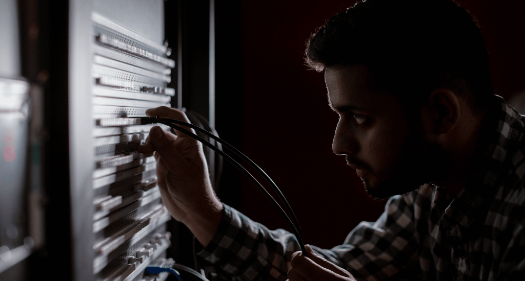 Man plug a cable in a server